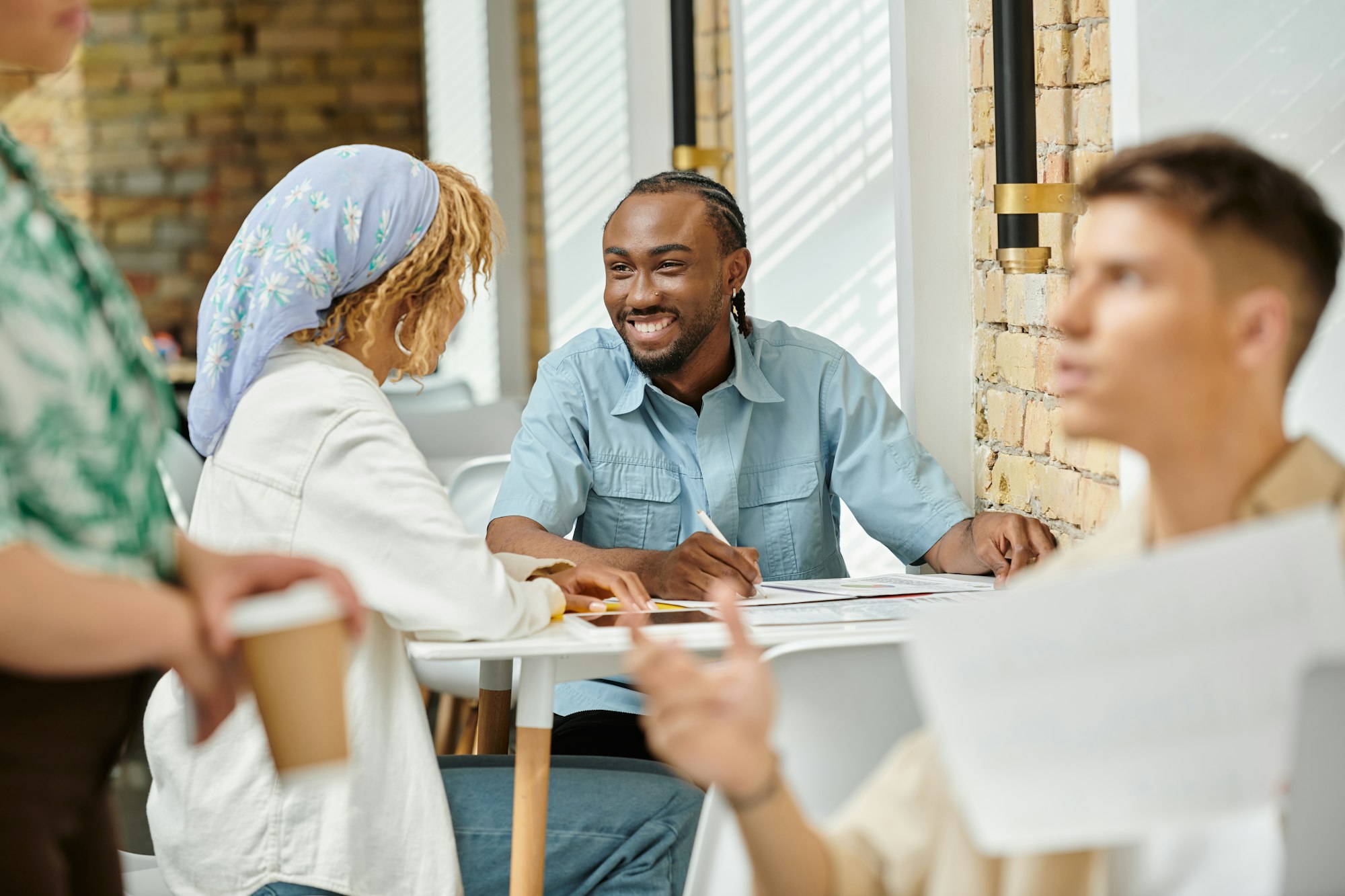 cheerful-african-american-coworkers-discussing-project-over-graphs-coworking-start-up-ideas.jpg